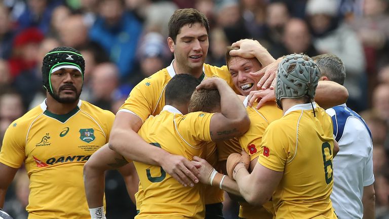 Reece Hodge is mobbed after scoring Australia's first try