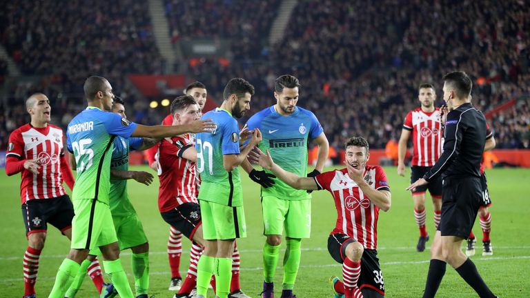Sam McQueen reacts following an elbow to the face from Inter's Antonio Candreva
