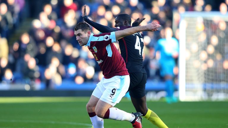 Sam Vokes of Burnley and Yaya Toure of Manchester City compete for the ball