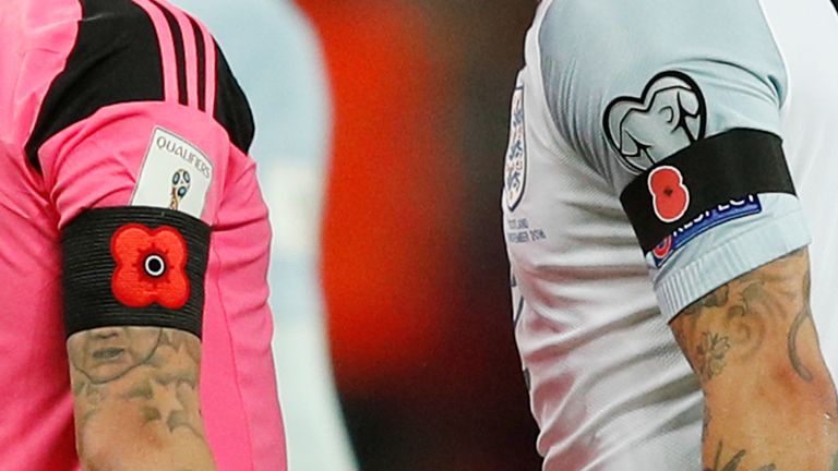In a picture taken on November 11, 2016 Poppy armbands worn by England's defender Kyle Walker (R) and Scotland's forward Leigh Griffiths (L) to comemorate 