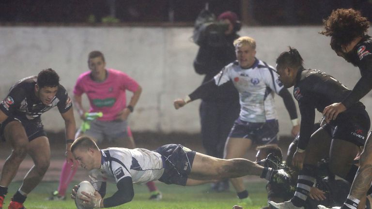 Scotland's Euan Aitkin goes over for a try