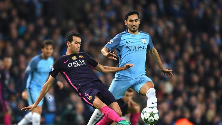 MANCHESTER, ENGLAND - NOVEMBER 01: Sergio Busquets of Barcelona (L) tackles Ilkay Gundogan of Manchester City (R) during the UEFA Champions League Group C 