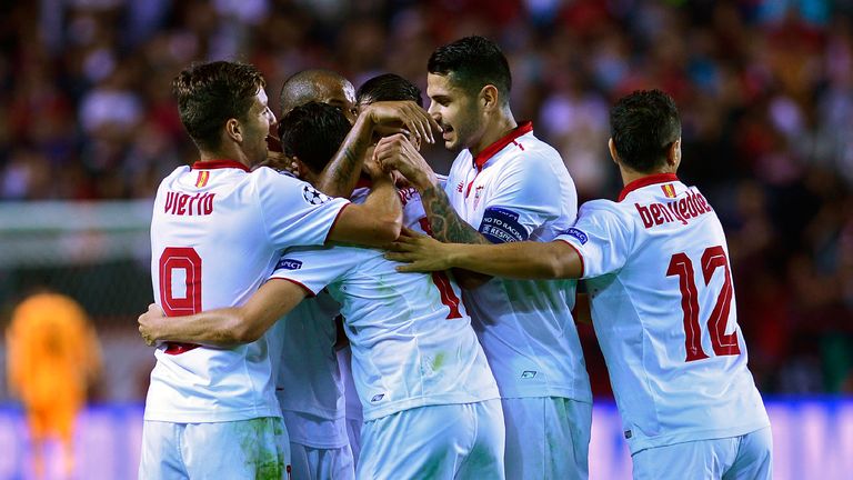 Sevilla's defender Sergio Escudero (2ndL) celebrates with teammates after scoring a goal during the UEFA Champions League Group H football match Sevilla FC