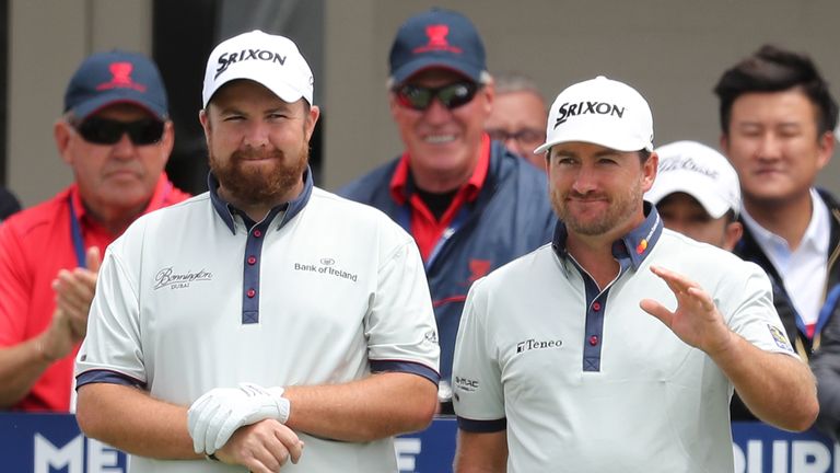 MELBOURNE, AUSTRALIA - NOVEMBER 24:  Shane Lowry and Graeme McDowell of Ireland gesture to the crowd during day one of the World Cup of Golf at Kingston He