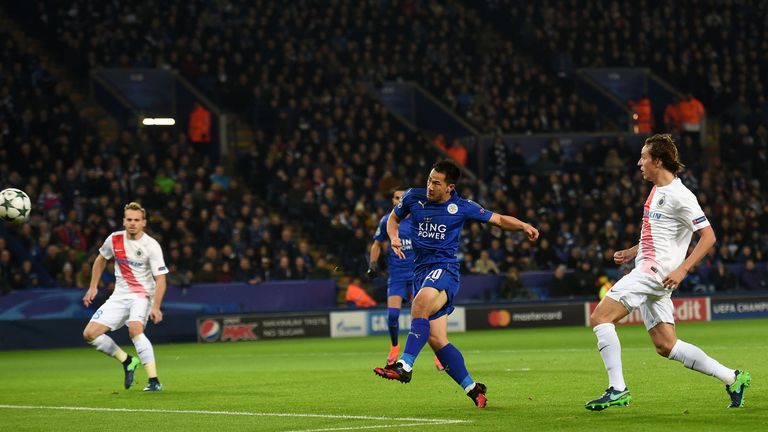 Leicester City's Japanese striker Shinji Okazaki (C) shoots to score their first goal 