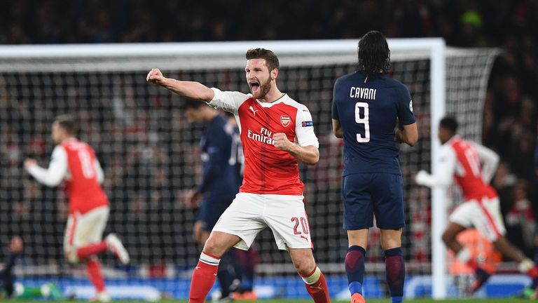 Arsenal's German defender Shkodran Mustafi (C) celebrates after Paris Saint-Germain's Italian midfielder Marco Verratti scored an own goal for Arsenal's se