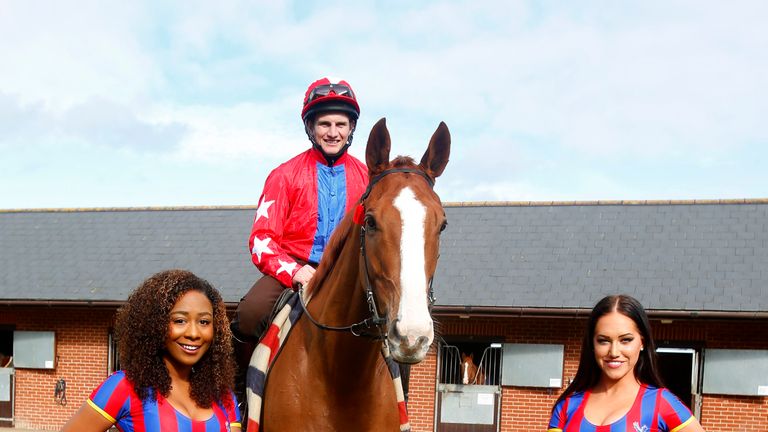 Jamie Moore poses on Sire De Grugy with the Crystal Palace cheerleaders