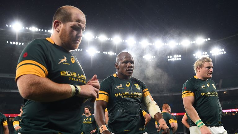 LONDON, ENGLAND - NOVEMBER 12:  l-r Lourens Adriaanse, Bongi Mbonambi and Adriaan Strauss of South Africa show their dissapoinment as they leave the field 