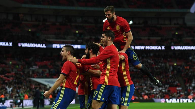 Isco of Spain (22) celebrates with team mates as he scores their second and equalising goal