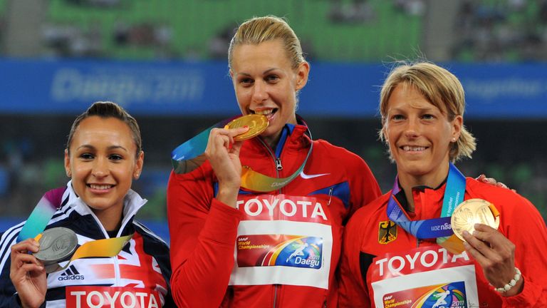 2011 gold medallist Russia's Tatyana Chernova (C) poses with silver medallist Britain's Jessica Ennis (L) and bronze medallist Germany's Jennifer Oeser (R)