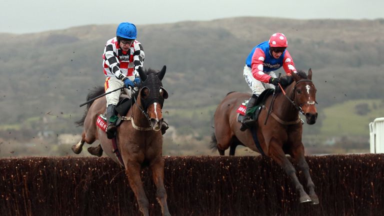 The Giant Bolster, ridden by Tom Scudamore, (left) jumps the last alongside Rocky Creek on his way to victory in the 2014 Argento Chase.