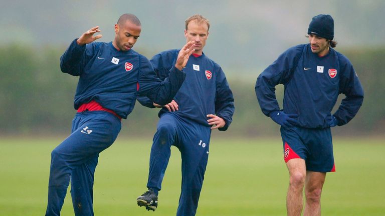 LONDON - APRIL 30:  Thierry Henry of Arsenal (L) shows off his skills to Dennis Bergkamp and Robert Pires (R) during the Arsenal Football Club training ses
