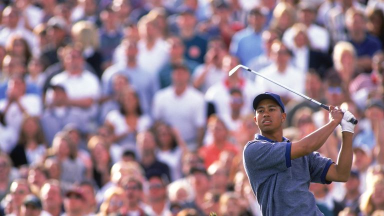 Tiger Woods watches intently after hitting his tee shot to 16, and moments later he was celebrating a hole in one