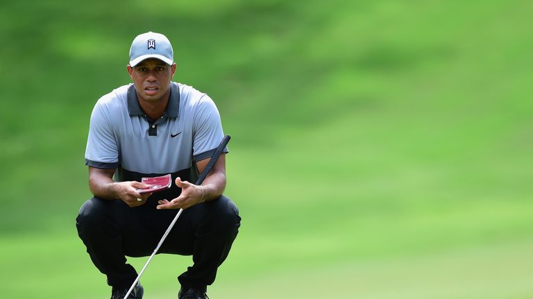 GREENSBORO, NC - AUGUST 22:  Tiger Woods lines up his putt on the fifth hole during the third round of the Wyndham Championship at Sedgefield Country Club 