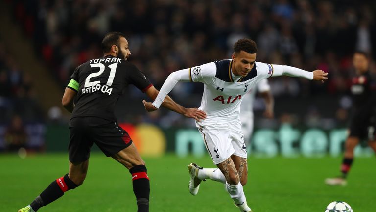 LONDON, ENGLAND - NOVEMBER 02:  Dele Alli of Tottenham Hotspur skips past Omer Toprak of Bayer Leverkusen during the UEFA Champions League Group E match be
