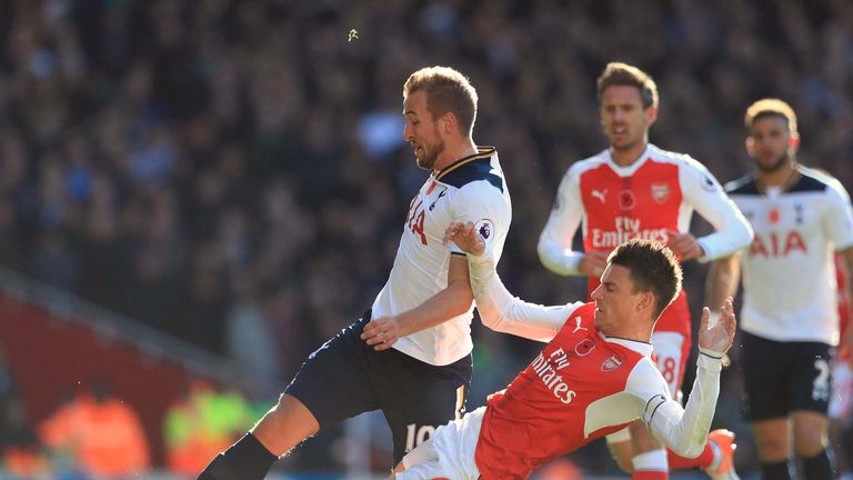 Tottenham Hotspur's Harry Kane and Arsenal's Laurent Koscielny battle for the ball