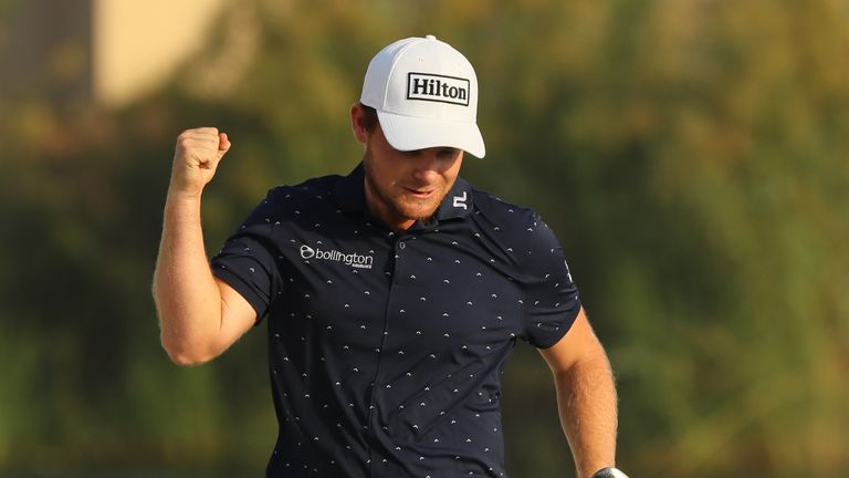 DUBAI, UNITED ARAB EMIRATES - NOVEMBER 20:  Tyrrell Hatton of England reacts to holing his bunker shot on the 17th hole for par during day four of the DP W