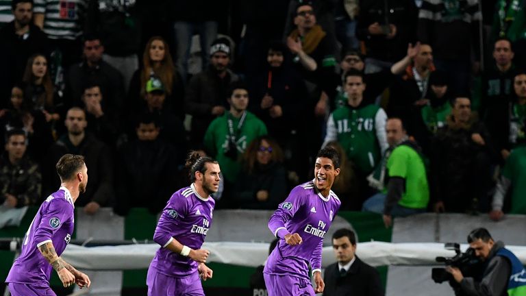 Real Madrid's defender Raphael Varane (R) celebrates after scoring the opening goal during the UEFA Champions League football match Sporting CP vs Real Mad