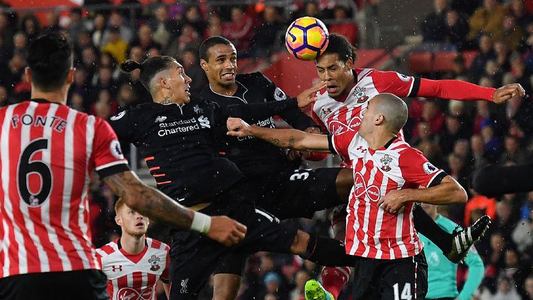 Liverpool's Brazilian midfielder Roberto Firmino (L) and Liverpool's German-born Cameroonian defender Joel Matip (2L) vie in the air with Southampton's Dut