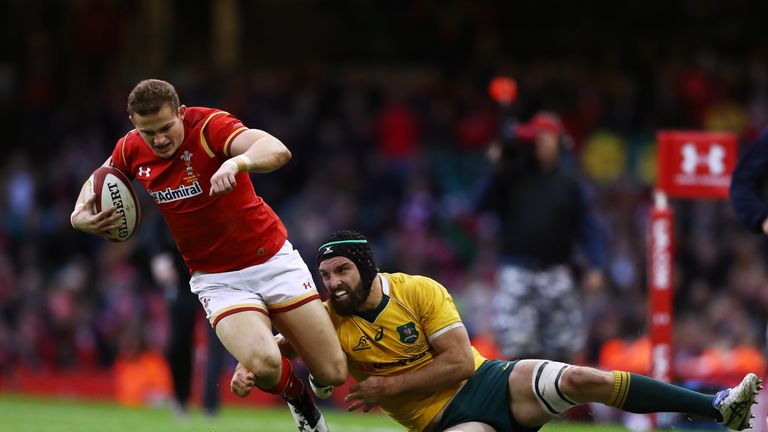 Hallam Amos of Wales is hauled down by Scott Fardy of Australia 