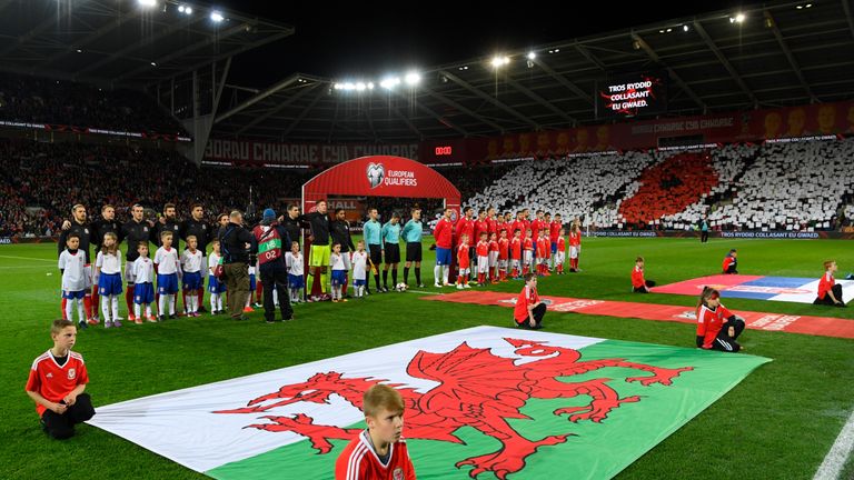 The Wales and Serbia players line up for the national anthems prior to their World Cup Qualifier in Cardiff