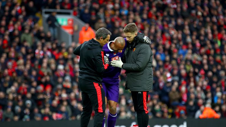 Heurelho Gomes leaves the pitch following an injury against Liverpool