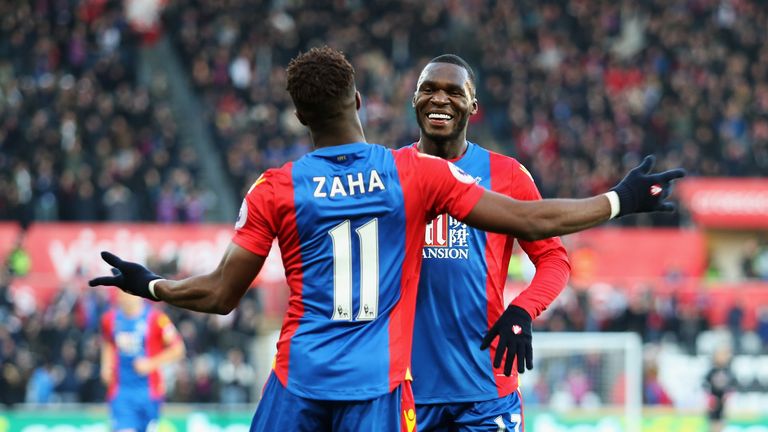 SWANSEA, WALES - NOVEMBER 26: Wilfried Zaha (L) of Crystal Palace celebrates scoring the opening goal with his team mate Christian Benteke (R) during the P
