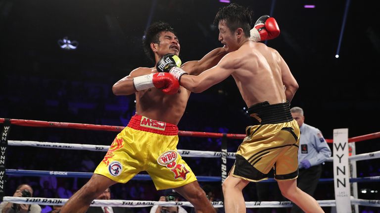 LAS VEGAS, NV - NOVEMBER 05:   (R-L) Zou Shiming of China lands a left to the head of opponent Prasitsak Phaprom of Thailand during their WBO flyweight cha