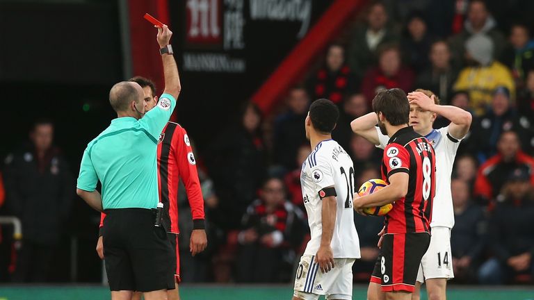 Steven Pienaar of Sunderland (R) is shown a red card by Mike Dean (L) during the Premier League match at AFC Bournemouth