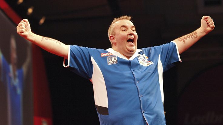 England's Phil Taylor celebrates his 15th World champion title after defeating Australia's Simon Whitlock in the final of the 2010 World Darts Championship