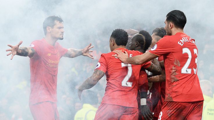 Sadio Mane and his Liverpool team-mates celebrate his late winner surrounded by smoke from a flare