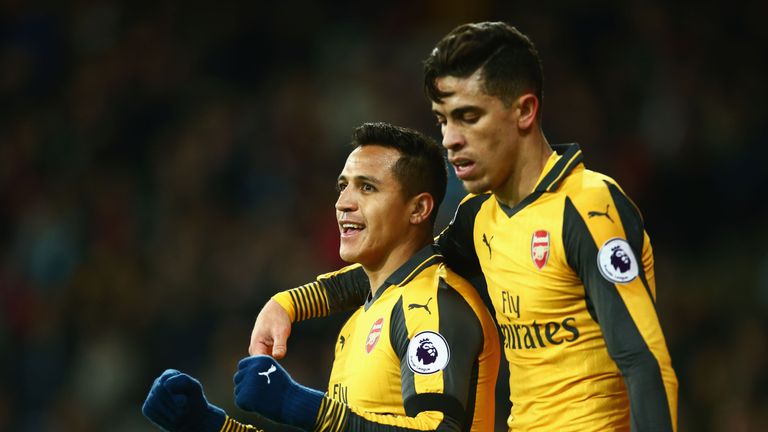 Alexis Sanchez of Arsenal celebrates with Gabriel Paulista after scoring his team's second goal during the Premier League match at West Ham