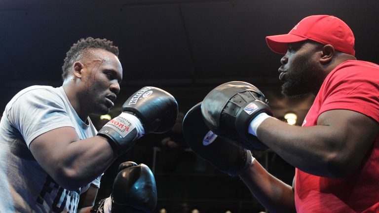 British boxer Dereck Chisora (L) attends a public training with his coach Don Charles in Munich, southern Germany, on February 15, 2012. WBC World Champion