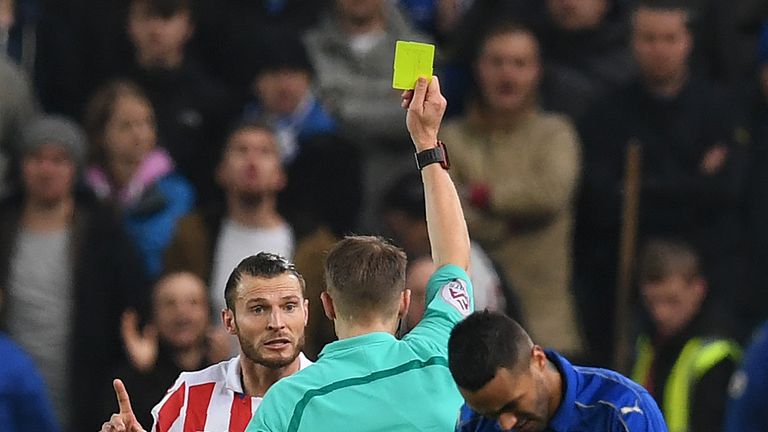 Craig Pawson shows a yellow card to Stoke City's Dutch defender Erik Pieters in their 2-2 draw with Leicester