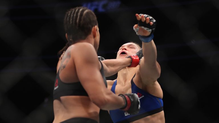 LAS VEGAS, NV - DECEMBER 30: (L-R) Amanda Nunes of Brazil punches Ronda Rousey in their UFC women's bantamweight championship bout during the UFC 207 event