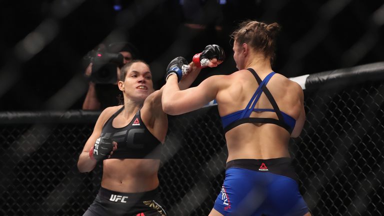 LAS VEGAS, NV - DECEMBER 30: (R-L) Amanda Nunes of Brazil punches Ronda Rousey in their UFC women's bantamweight championship bout during the UFC 207 event