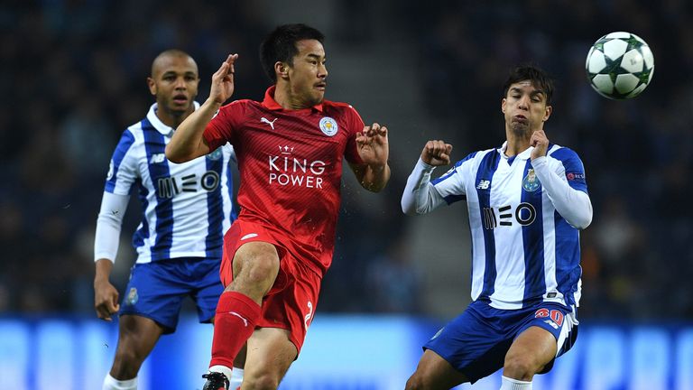 Shinji Okazaki of Leicester City (L) and Alex Telles of FC Porto (R) battle for possession during the UEFA Champions League match