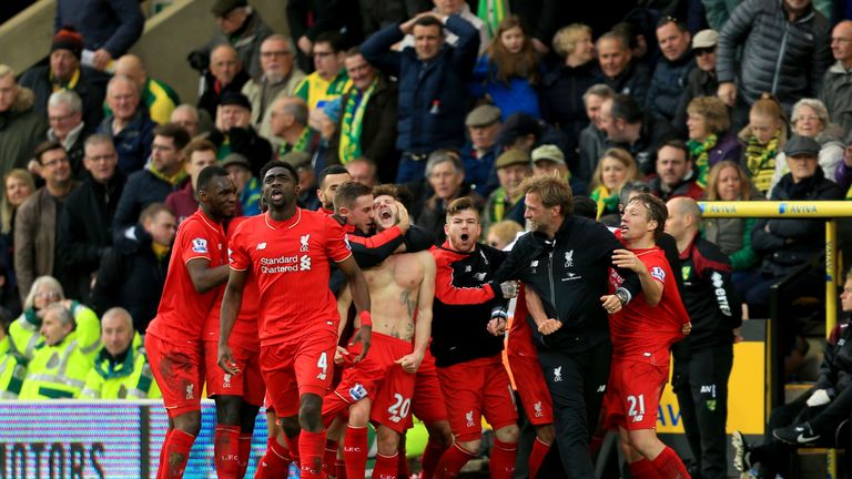 NORWICH, ENGLAND - JANUARY 23:  Adam Lallana (C) of Liverpool ceelbrates scoring his team's fifth goal with his team mates and manager Jurgen Klopp (2nd R)