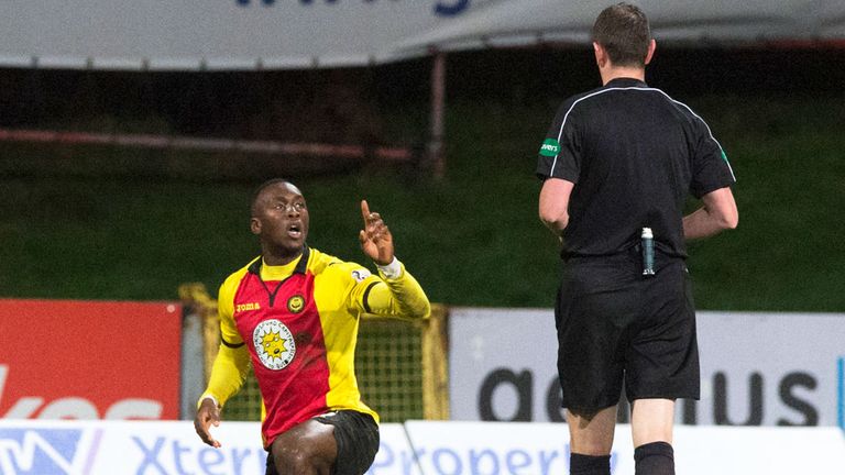 Referee Craig Thomson prepares to book Partick striker Ade Azeez