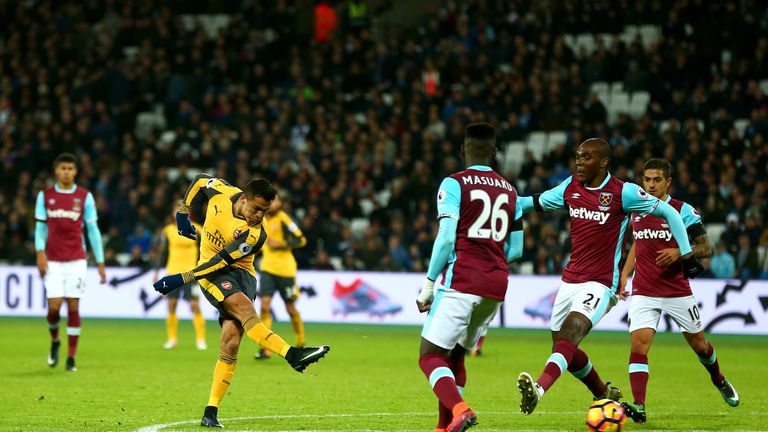 Alexis Sanchez of Arsenal scores their third goal during the Premier League match between West Ham United and Arsenal
