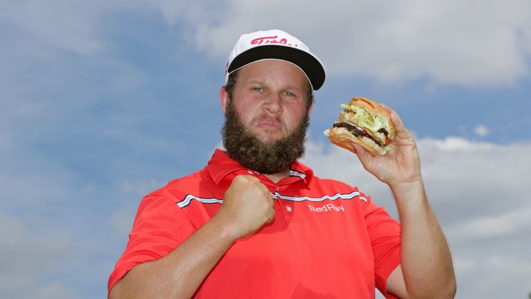 AKRON, OH - JULY 02:  Andrew Johnston of England poses for a portrait with a hamburger after the third round of the World Golf Championships - Bridgestone 