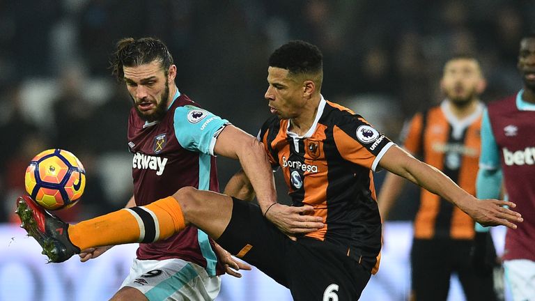 West Ham United's English striker Andy Carroll (L) vies with Hull City's English defender Curtis Davies during the English Premier League football