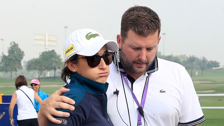 Anne-Lise Caudal is consoled by Tournament Director Michael Wood after her caddie collapsed and died