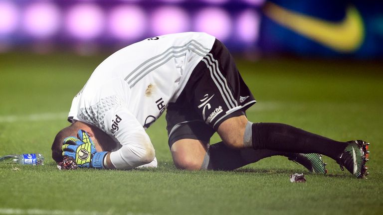 Lyon's Portuguese goalkeeper Anthony Lopes reacts after a firecracker exploded beside him on Saturday
