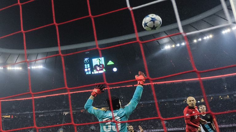 Bayern Munich's Dutch midfielder Arjen Robben scores the forth goal past Arsenal's Czech goalkeeper Petr Cech during the UEFA Champions League Group F seco
