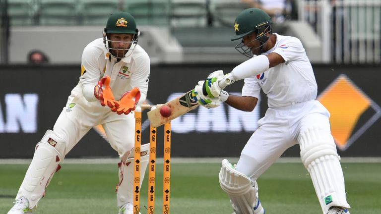Pakistan batsman Asad Shafiq (R) cuts a ball away as Australia's wicketkeeper Matthew Wade (L) looks on on the second day of the second cricket Test match 