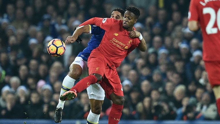 Everton's English-born Welsh defender Ashley Williams (L) vies with Liverpool's Belgian striker Divock Origi during the English Premier League football mat