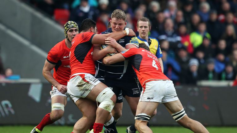 SALFORD, ENGLAND - NOVEMBER 20: Ross Harrison of Sale Sharks is tackled by Mike Rhodes (R) of Saracens during the Aviva Premiership match between Sale Shar