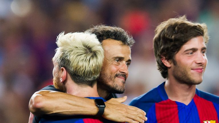 Head coach Luis Enrique and Lionel Messi of FC Barcelona embrace 