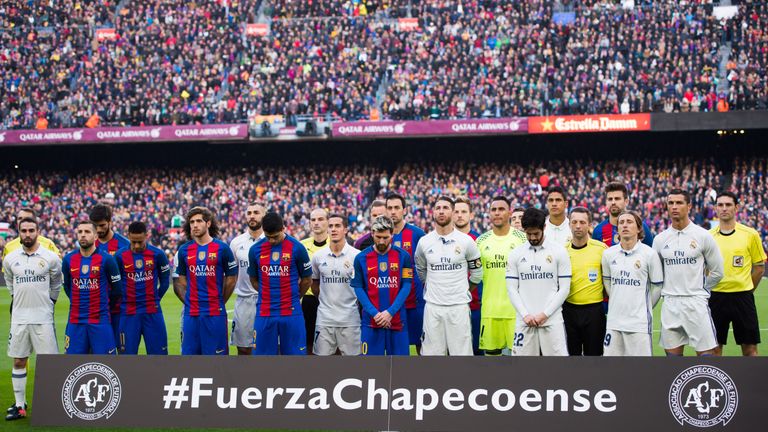 BARCELONA, SPAIN - DECEMBER 03: Players of FC Barcelona and Real Madrid CF and officials observe a minute of silence in memory of the victims of the plane 